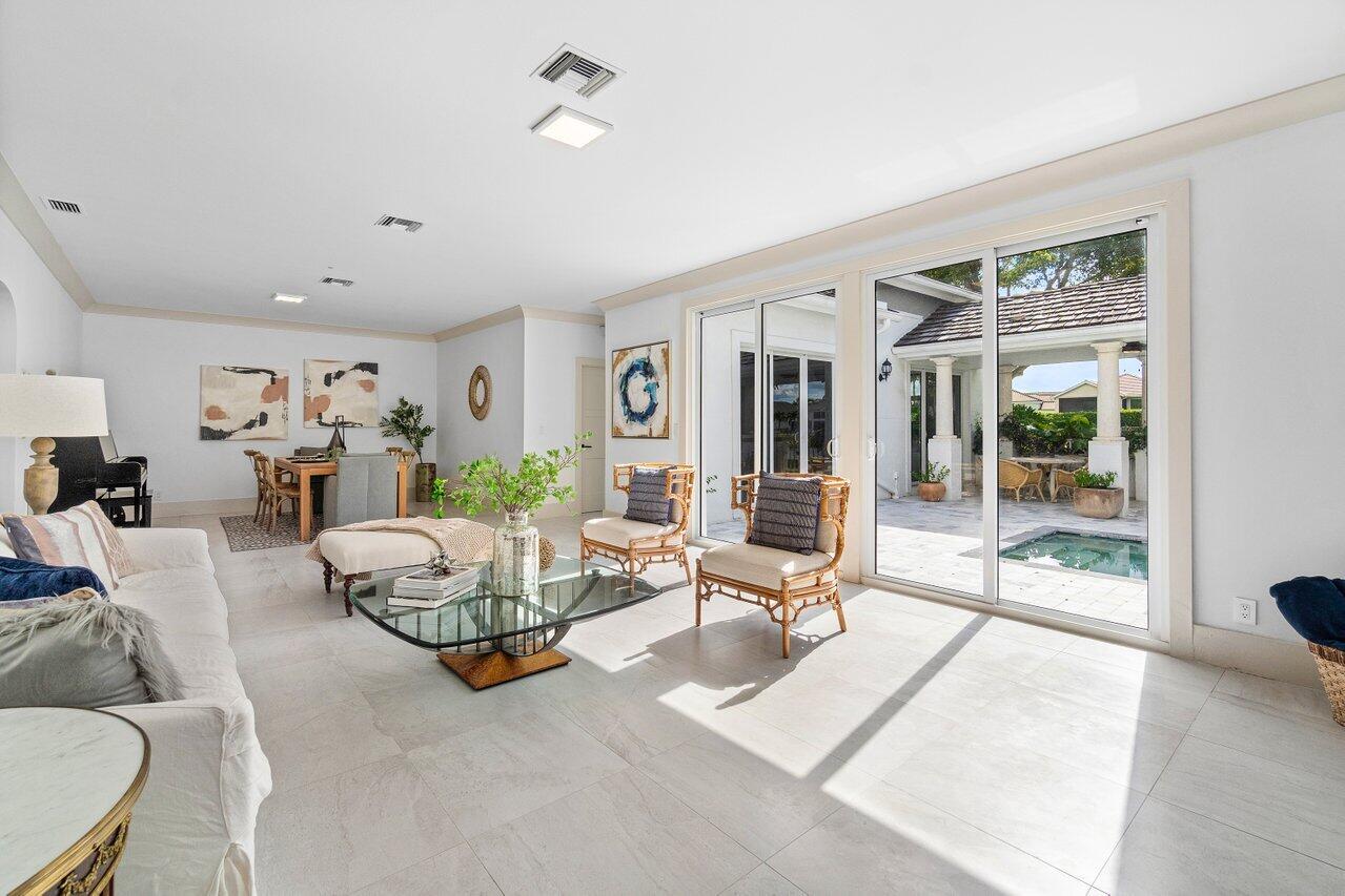 5848 Northwest 39th Avenue Boca Raton, FL 33496 - Photo 8 of 37 a living room with furniture and a large window
