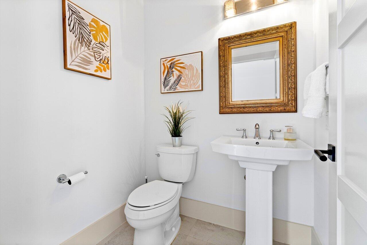 5848 Northwest 39th Avenue Boca Raton, FL 33496 - Photo 9 of 37 a bathroom with a toilet sink and mirror