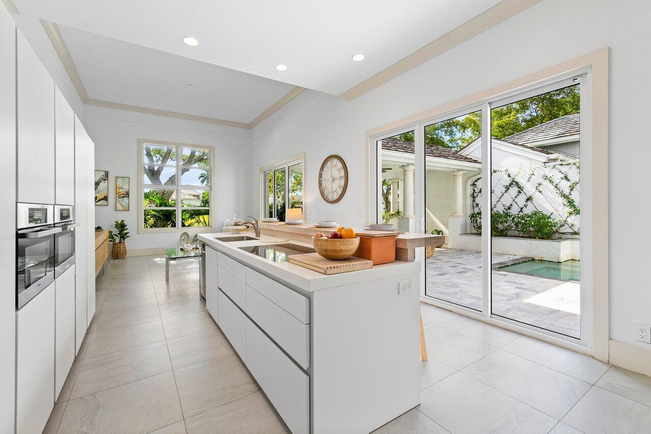 5848 Northwest 39th Avenue Boca Raton, FL 33496 - Photo 10 of 37 a kitchen with a stove and a sink