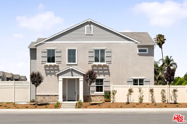 a front view of a house with a road