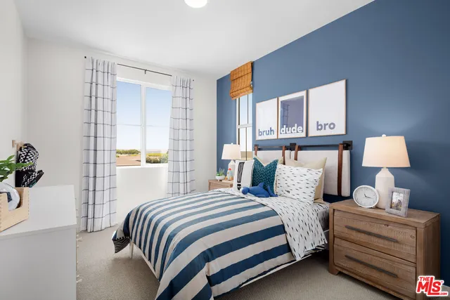 a bedroom with a bed and a lamp