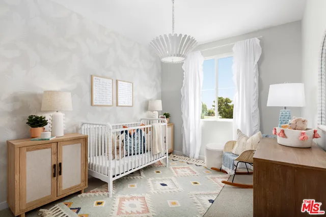 a bedroom with furniture and a window