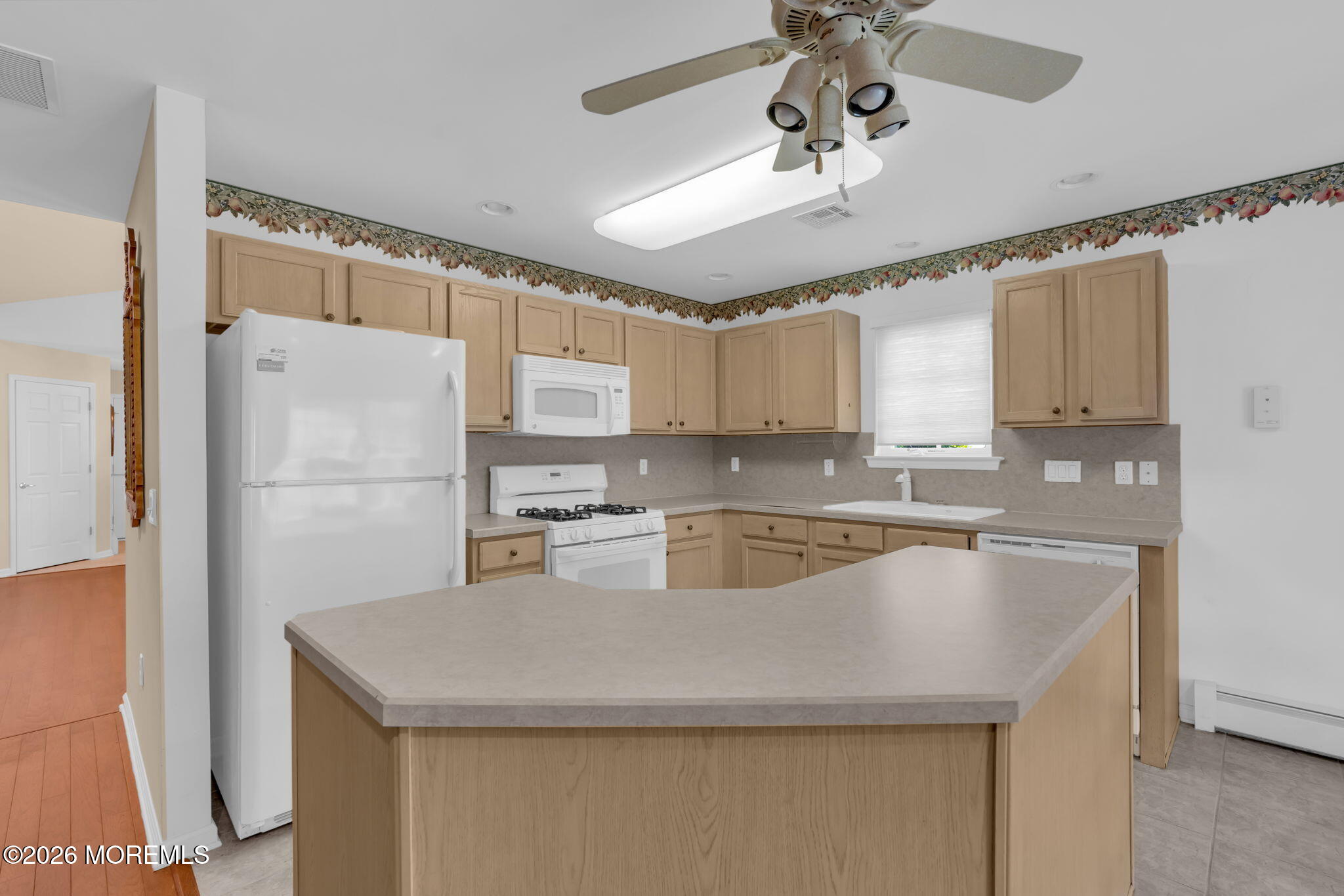 5 Round Valley Lane Lakewood, NJ 08701 - Photo 9 of 37 a kitchen with stainless steel appliances granite countertop a refrigerator a sink dishwasher a stove and white countertops with wooden floor