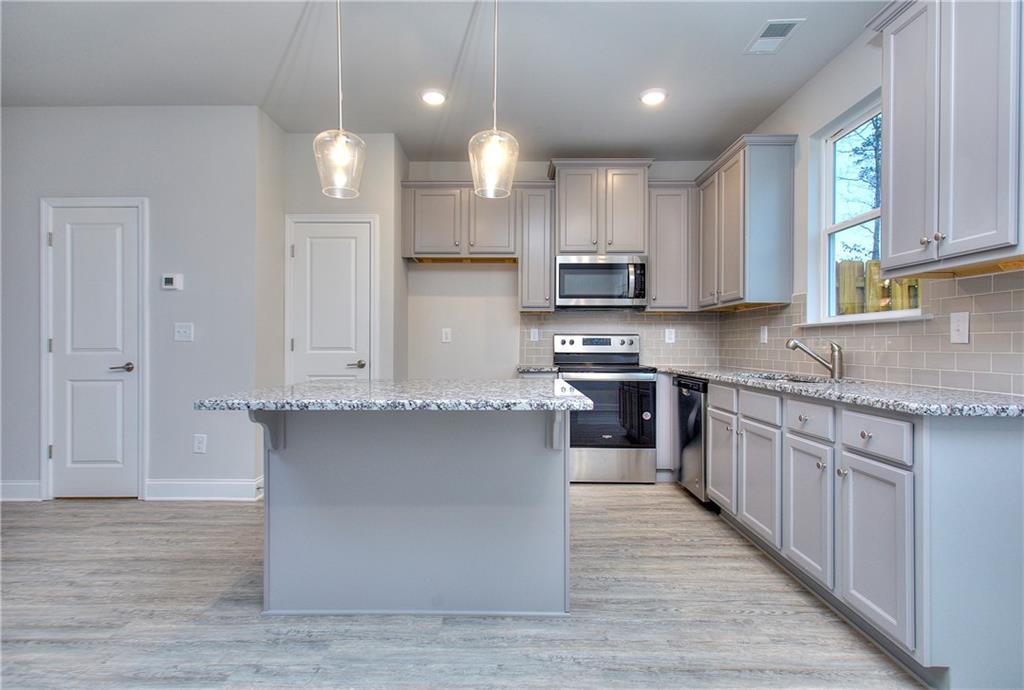 106 Greenview Court Cleveland, GA 30528 - Photo 15 of 29 a large kitchen with stainless steel appliances granite countertop a stove a sink and a granite counter tops