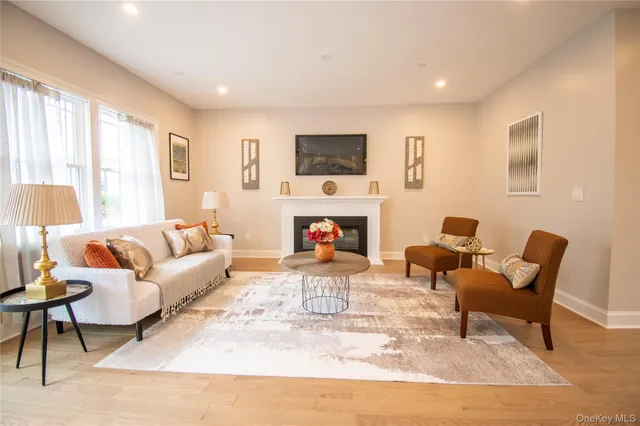 a living room with furniture a fireplace and a flat screen tv