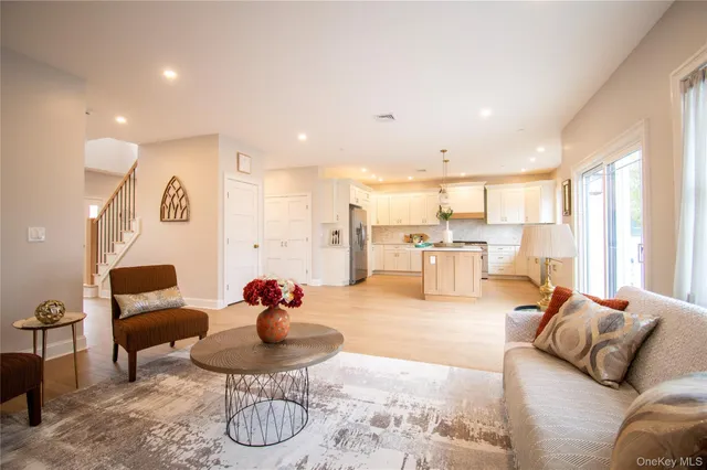 a living room with furniture and kitchen view