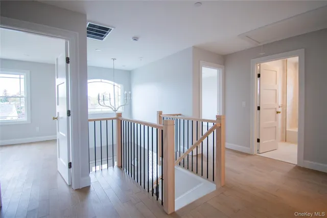 a view of hallway with wooden floor and stairs