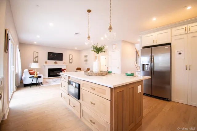 a kitchen with kitchen island a sink stove and refrigerator