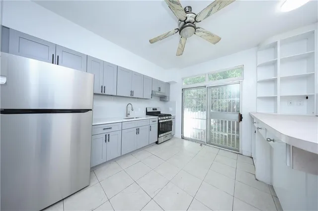 a kitchen with white cabinets and white appliances