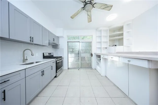 a large kitchen with a stove a sink dishwasher and a refrigerator