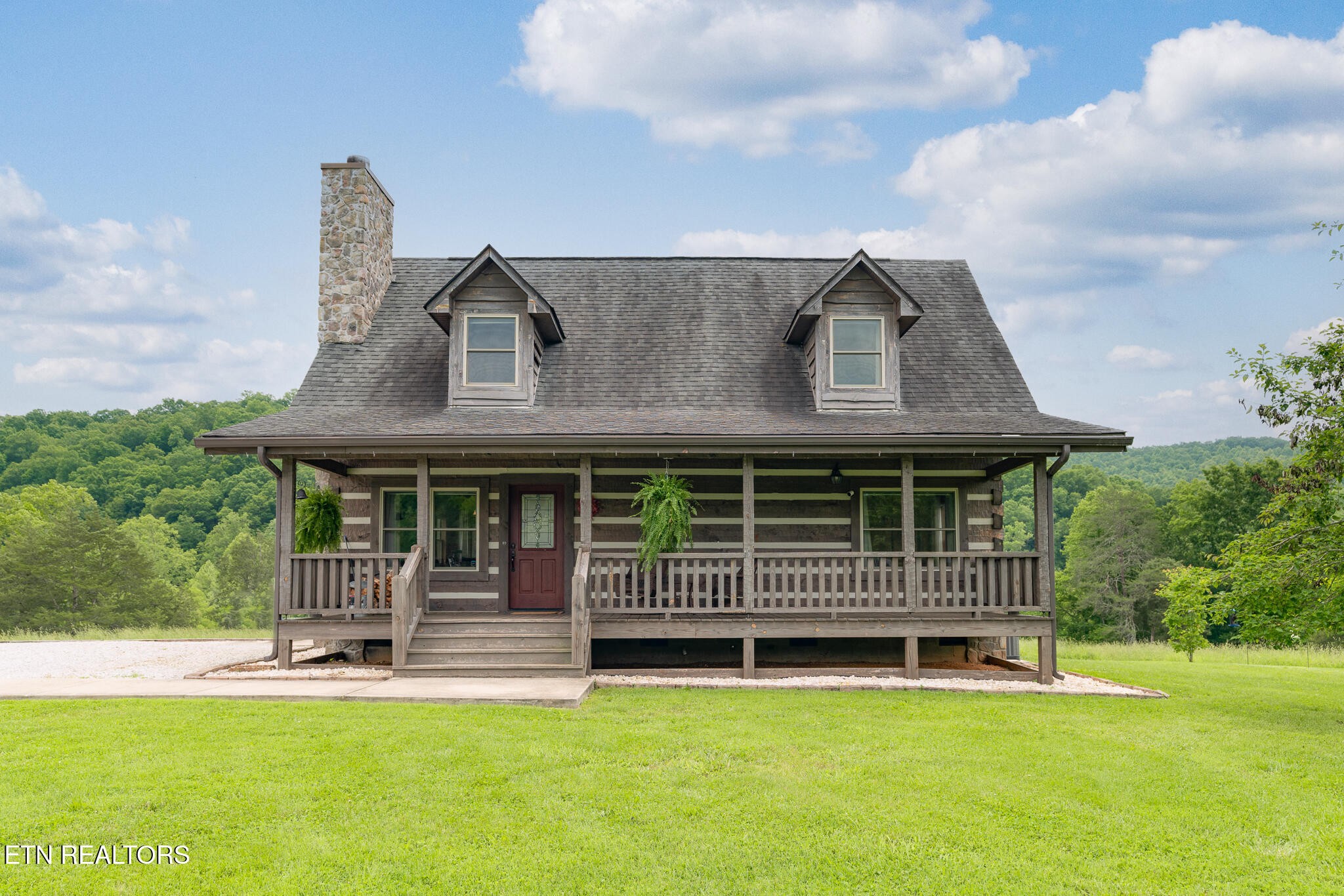 1055 Laurel Bluff Road Kingston, TN 37763 - Photo 3 of 35 a front view of a house with a garden and deck