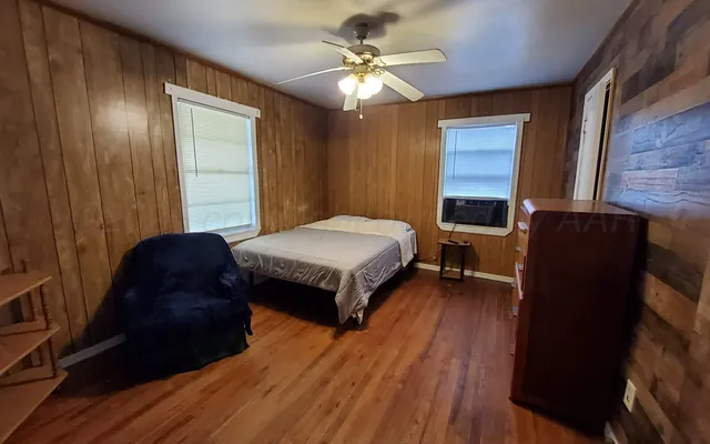 a living room with a bed furniture and a window