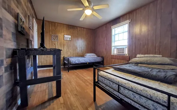 a bedroom with furniture and a window