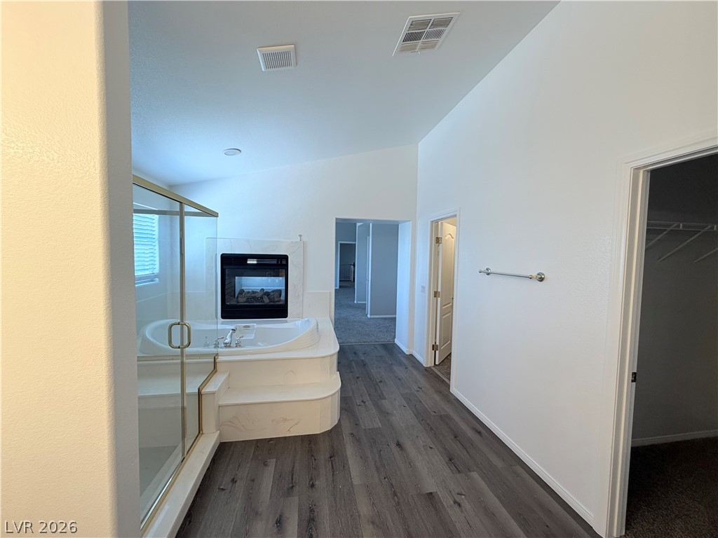 6116 Rabbit Track Street Las Vegas, NV 89130 - Photo 13 of 28 Indulge in a luxurious primary bathroom featuring a large soaking tub and a built-in fireplace.