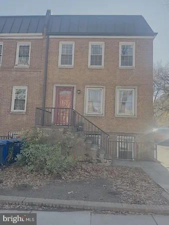 a view of a brick house with many windows