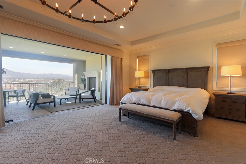 105 Iron Irvine, CA 92618 - Photo 26 of 47 a bed sitting in a spacious bedroom next to a lamp