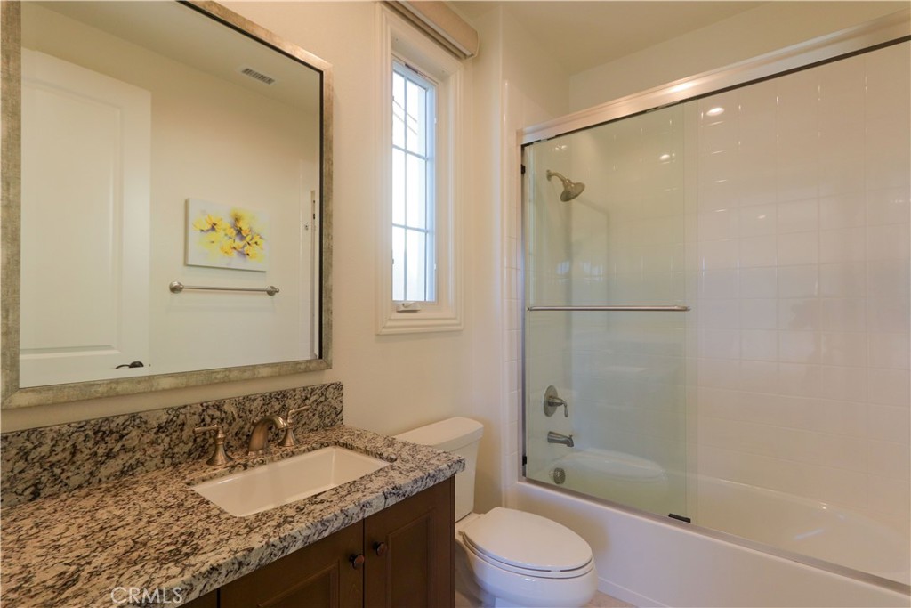 105 Iron Irvine, CA 92618 - Photo 35 of 47 a bathroom with a granite countertop sink toilet and shower