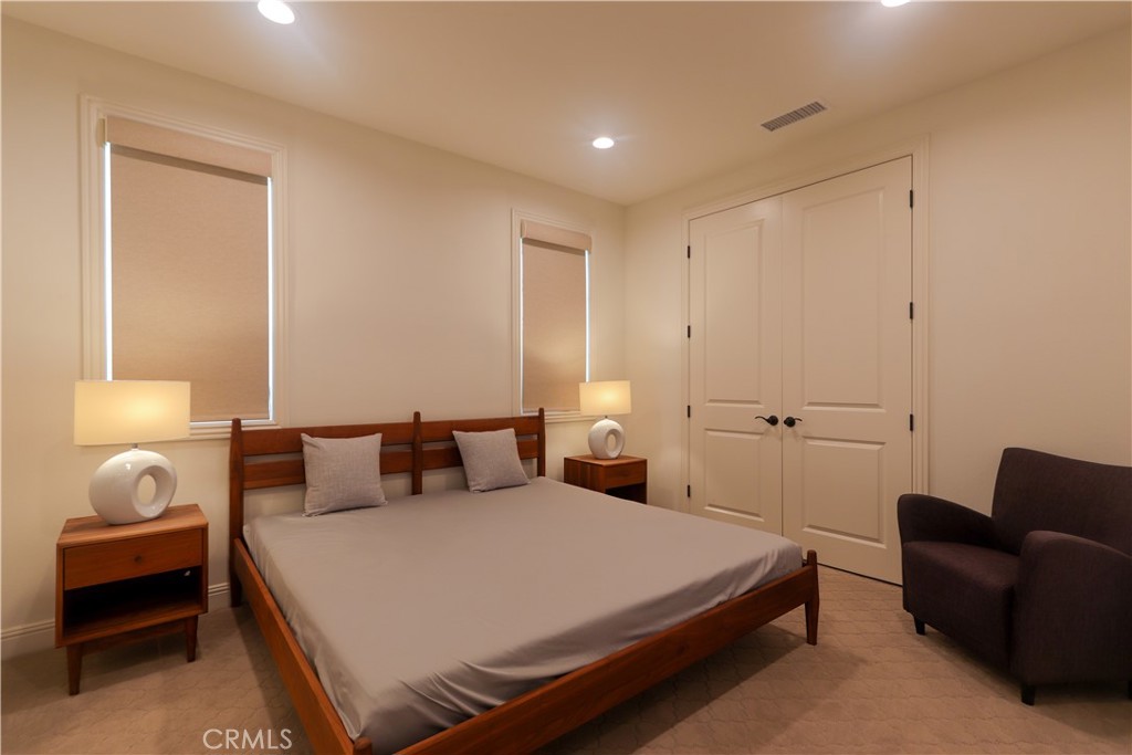 105 Iron Irvine, CA 92618 - Photo 36 of 47 a bedroom with a bed and a couch