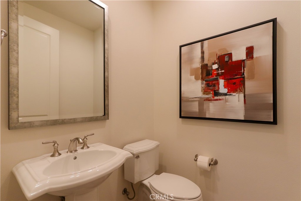 105 Iron Irvine, CA 92618 - Photo 7 of 47 a bathroom with a toilet sink and mirror