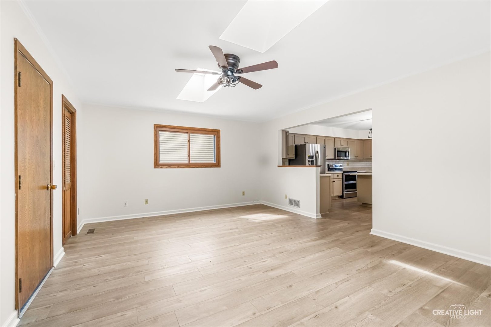 1483 Nova Road Sandwich, IL 60548 - Photo 7 of 29 a view of a livingroom with a hardwood floor and a ceiling fan