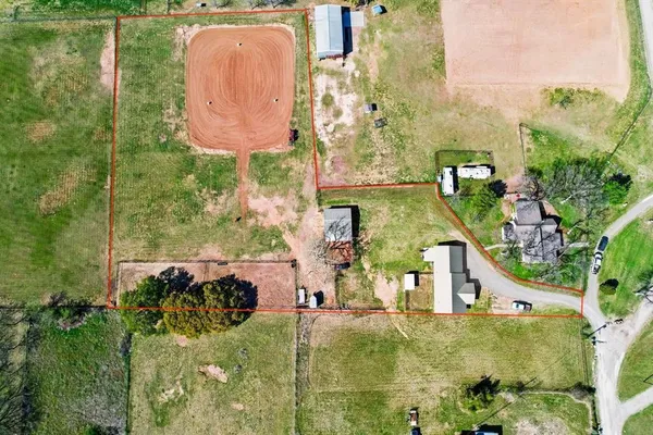 an aerial view of a house with swimming pool outdoor seating and yard