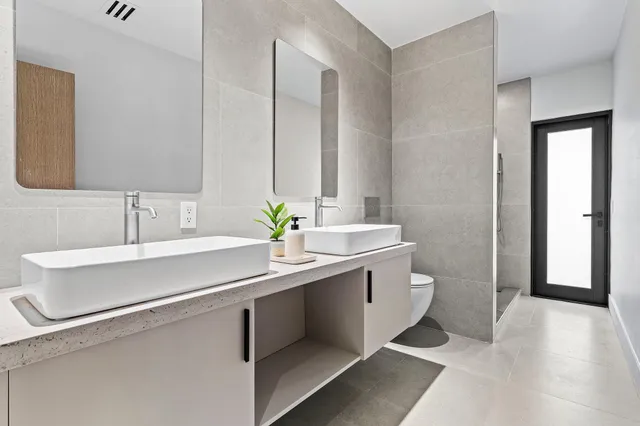 a bathroom with a sink double vanity and a mirror