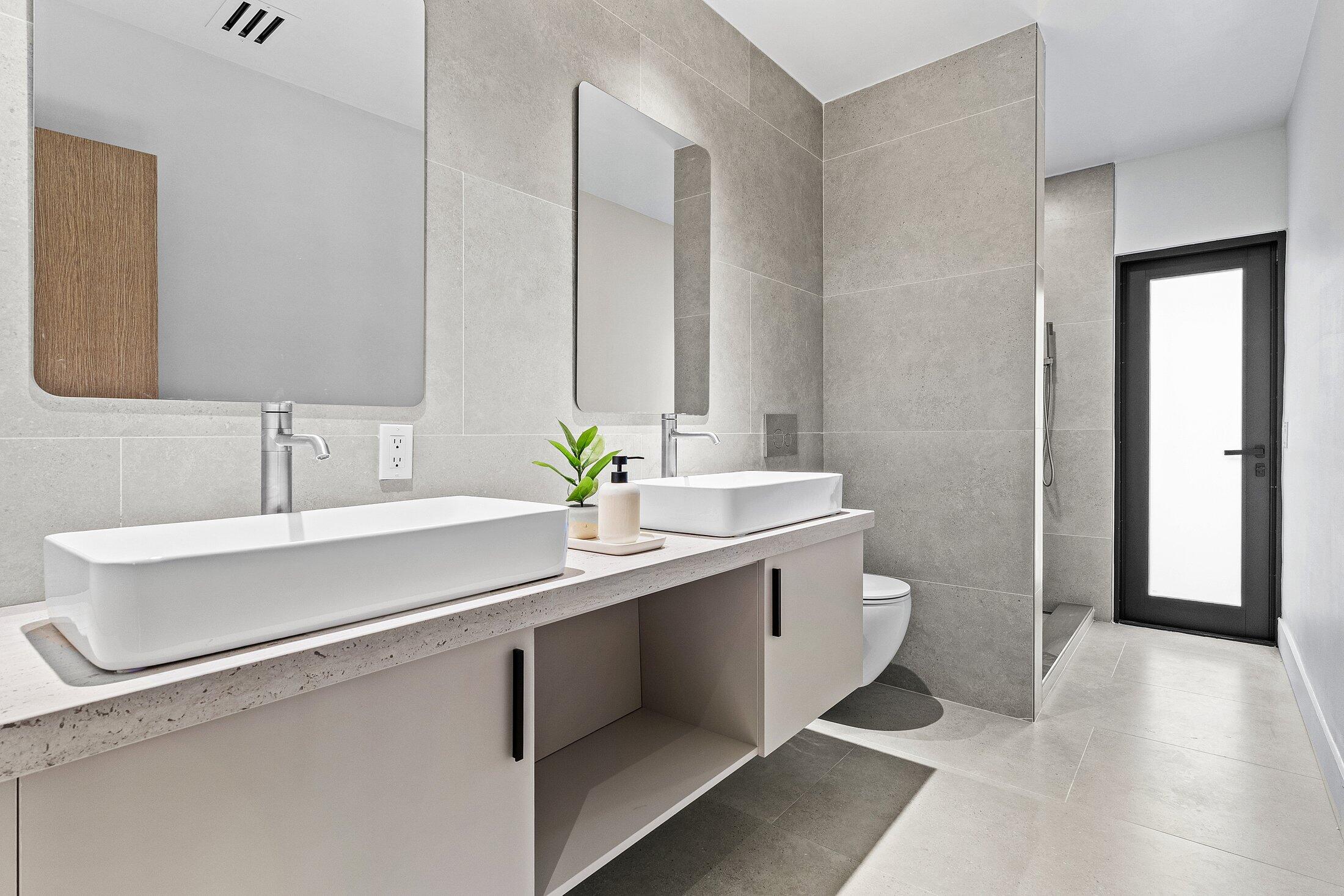 2668 Northwest 41st Street Boca Raton, FL 33434 - Photo 12 of 26 a bathroom with a sink double vanity and a mirror