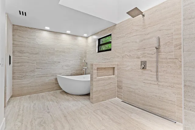 a bathroom with a bathtub and shower