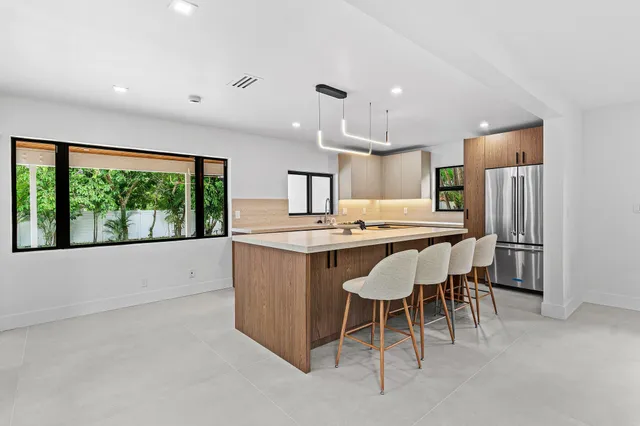a large kitchen with a table and chairs
