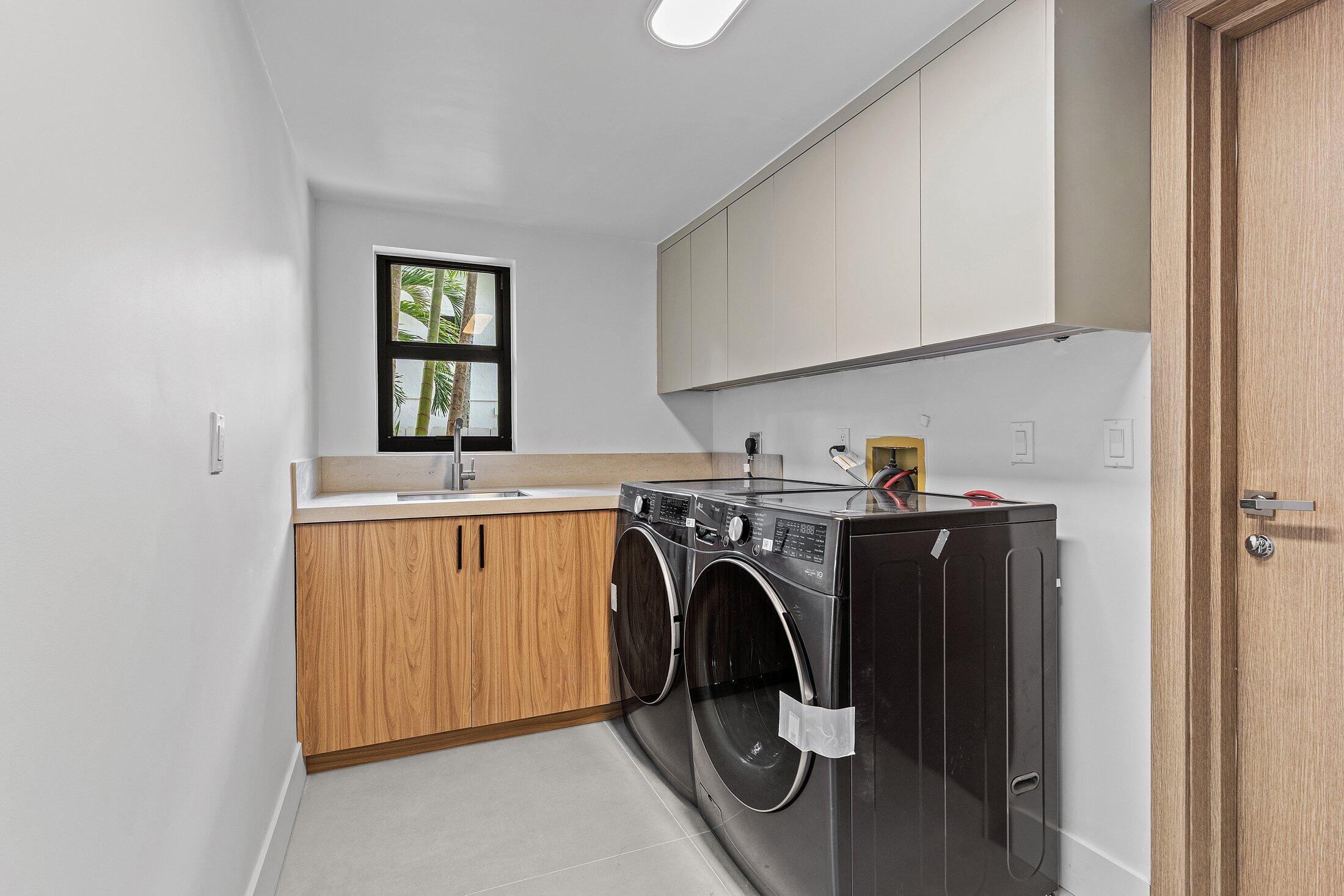 2668 Northwest 41st Street Boca Raton, FL 33434 - Photo 9 of 26 a utility room with dryer and washer