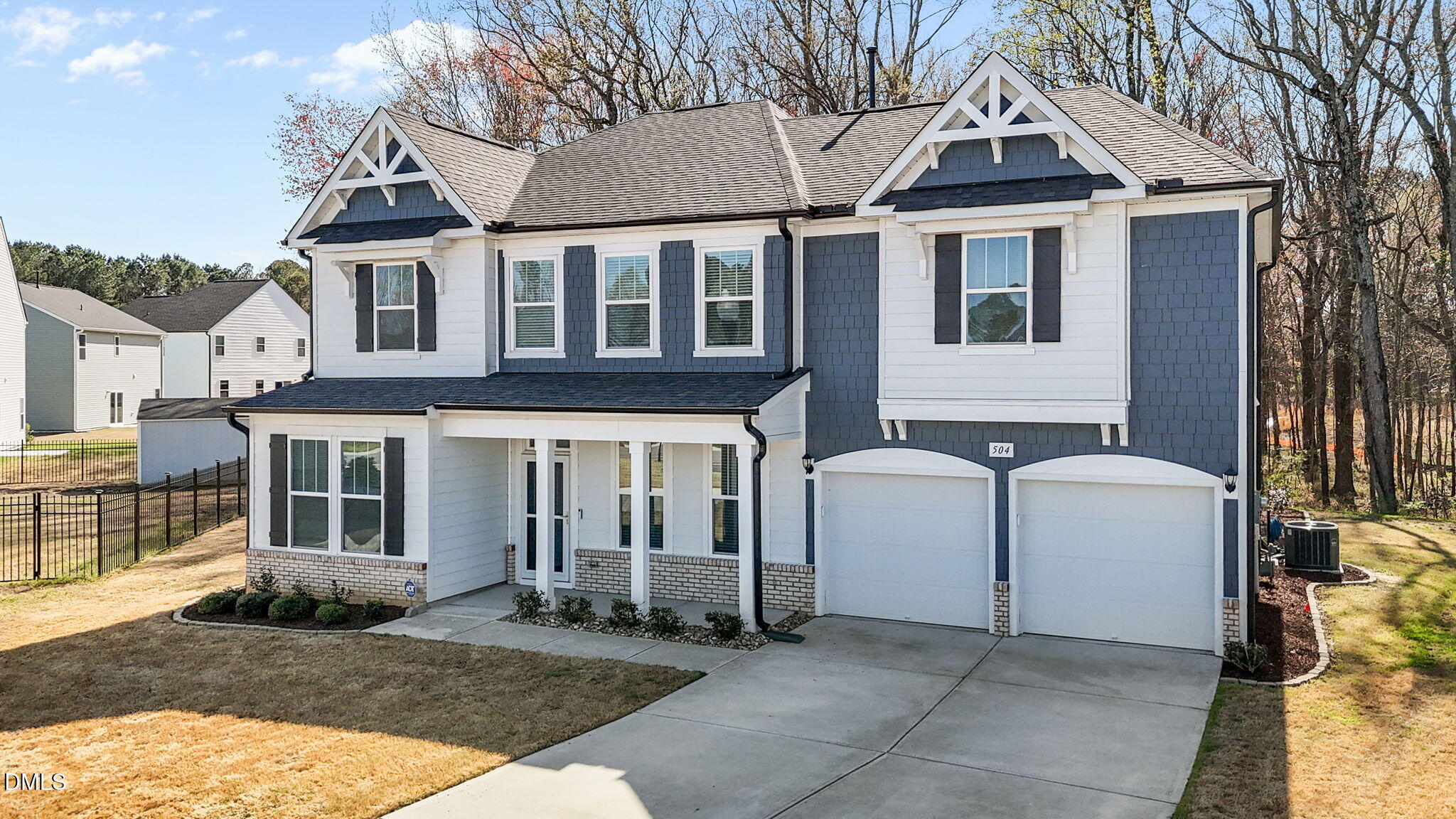 504 Henham Way Zebulon, NC 27597 - Photo 1 of 44 a view of a white house with large windows and a small yard