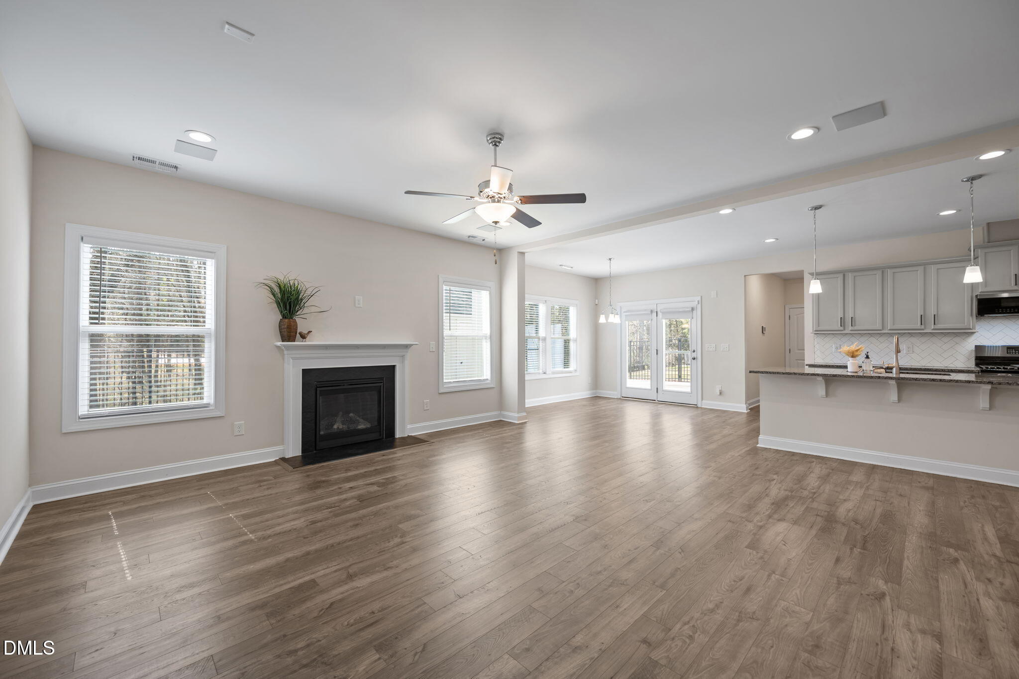 504 Henham Way Zebulon, NC 27597 - Photo 13 of 44 a view of an empty room with a fireplace and a window