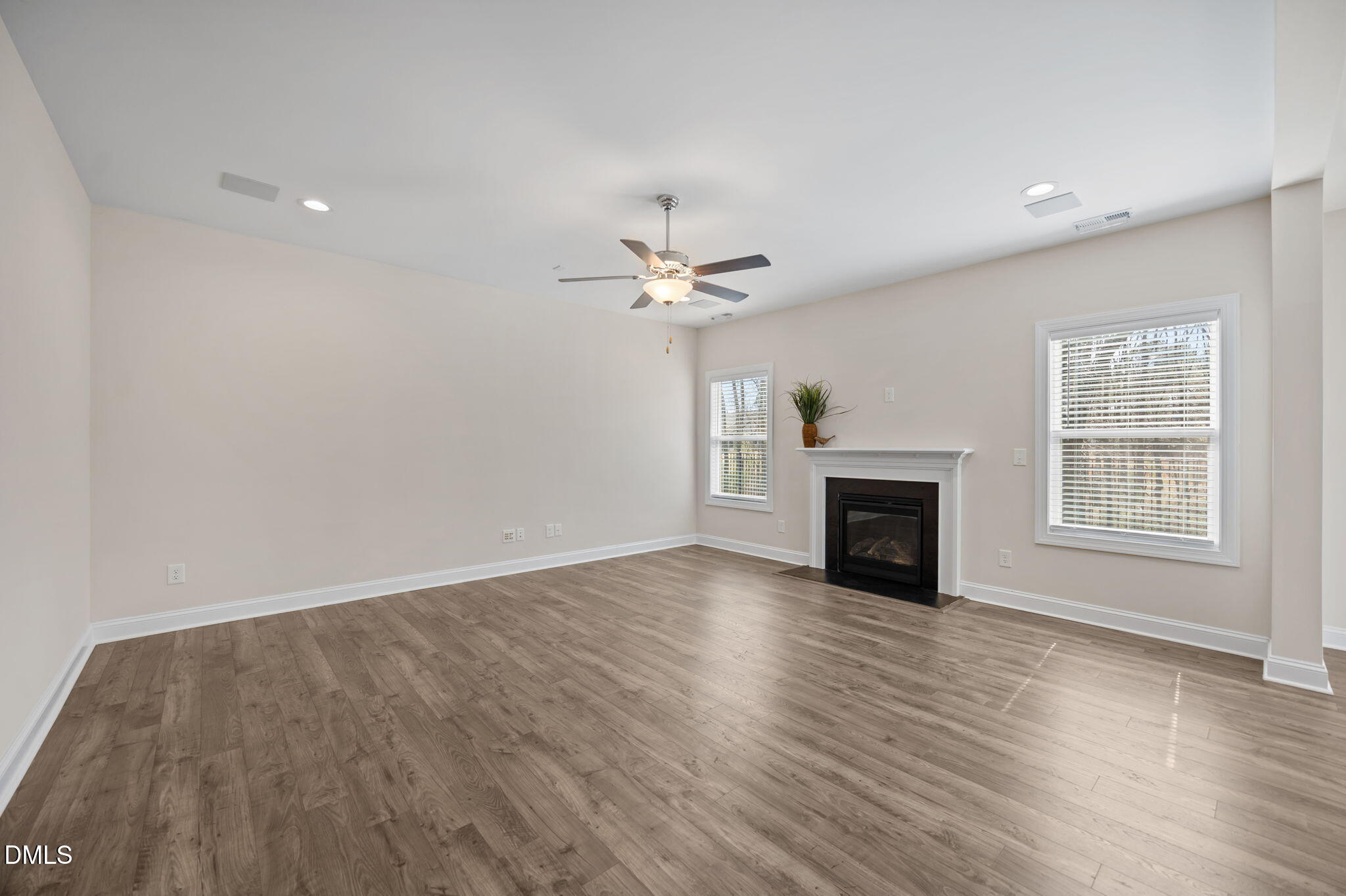 504 Henham Way Zebulon, NC 27597 - Photo 14 of 44 wooden floor in an empty room with a fireplace