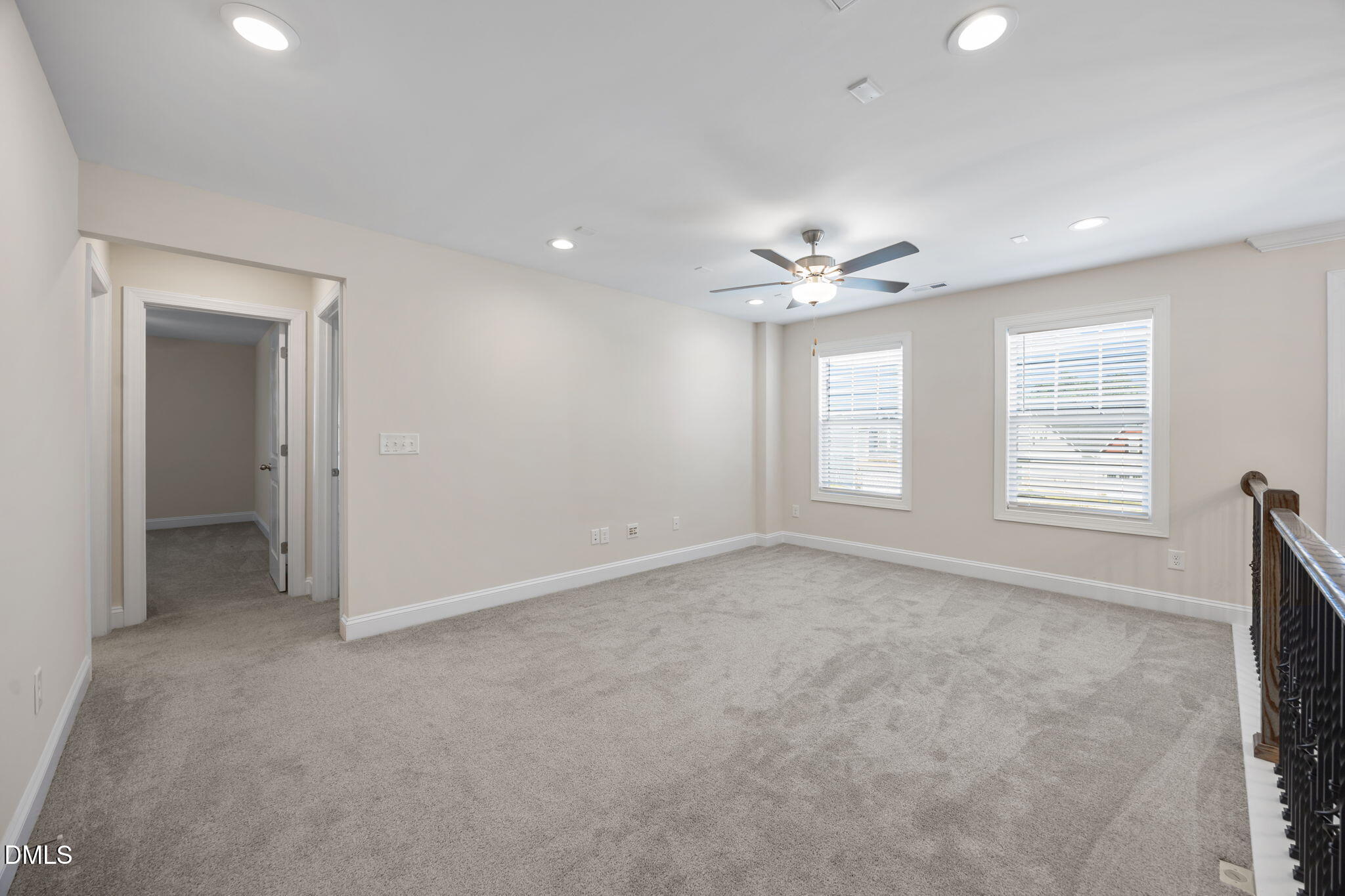 504 Henham Way Zebulon, NC 27597 - Photo 18 of 44 an empty room with windows and fan