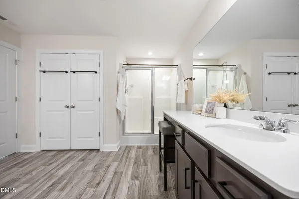 an empty room with closet and a ceiling fan