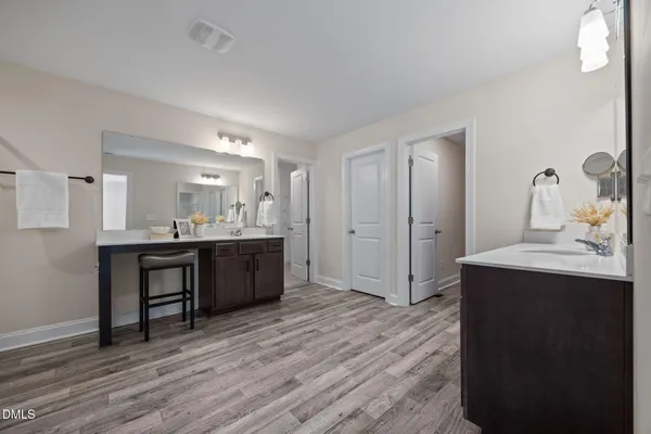 a bathroom with a sink a toilet a mirror and shower