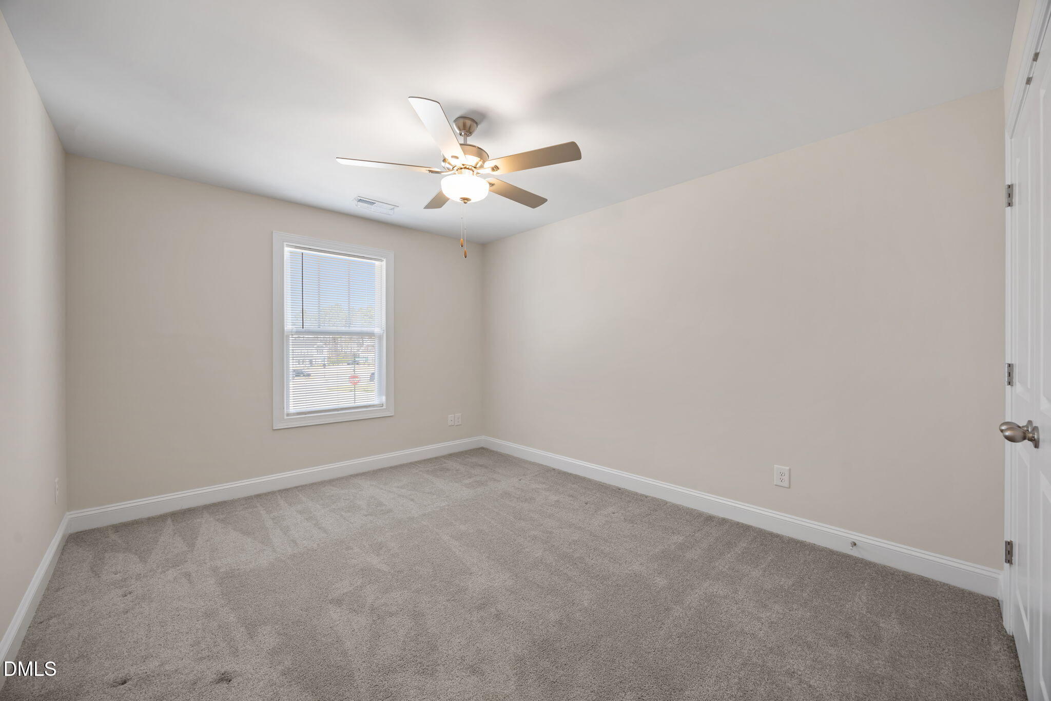 504 Henham Way Zebulon, NC 27597 - Photo 28 of 44 an empty room with a window and a fan