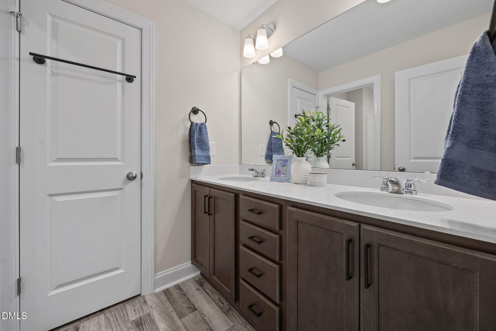 504 Henham Way Zebulon, NC 27597 - Photo 29 of 44 a bathroom with a double vanity sink and a mirror