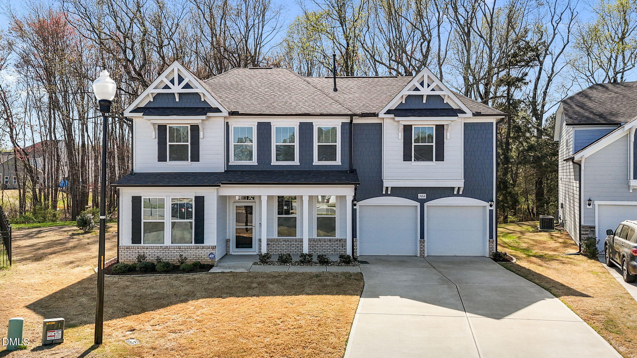 504 Henham Way Zebulon, NC 27597 - Photo 2 of 44 a view of a white house with large windows next to a road