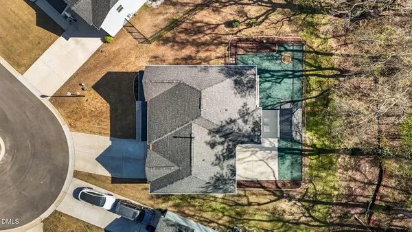 an aerial view of a house with outdoor space and sitting area