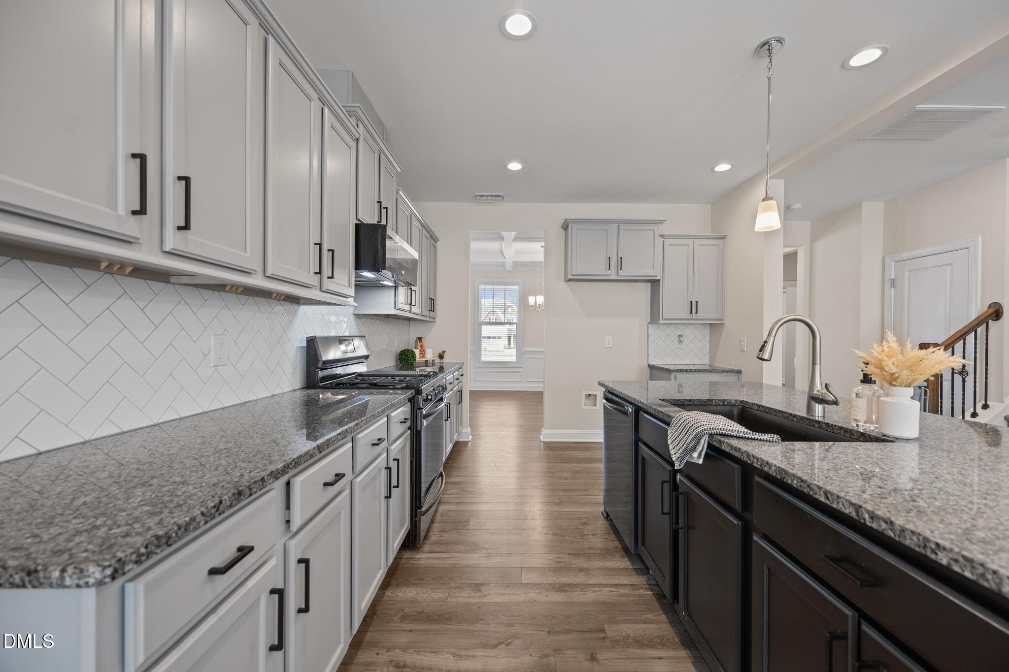 504 Henham Way Zebulon, NC 27597 - Photo 7 of 44 a kitchen with stainless steel appliances granite countertop a sink stove and cabinets