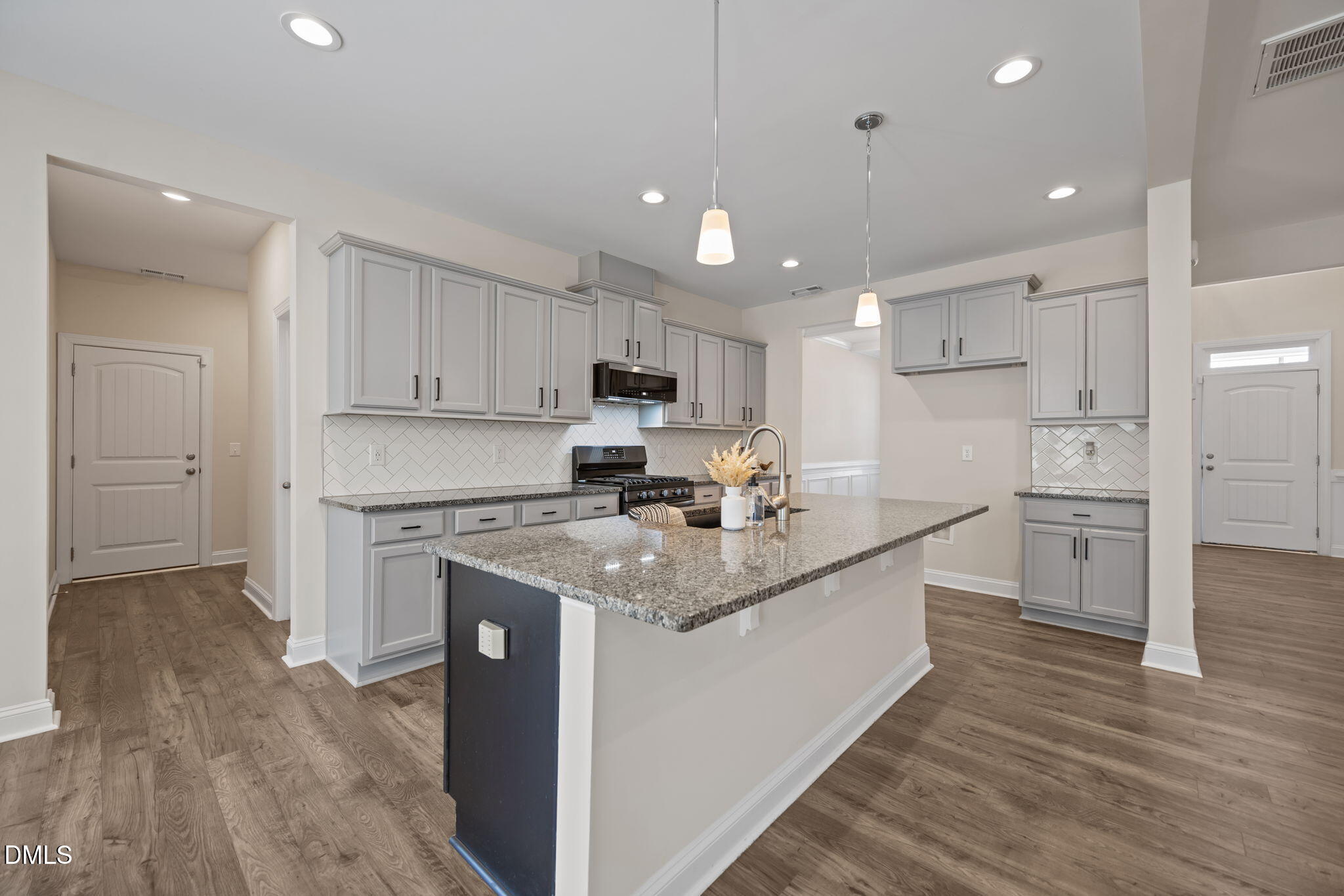 504 Henham Way Zebulon, NC 27597 - Photo 9 of 44 a kitchen with stainless steel appliances granite countertop a sink stove and refrigerator