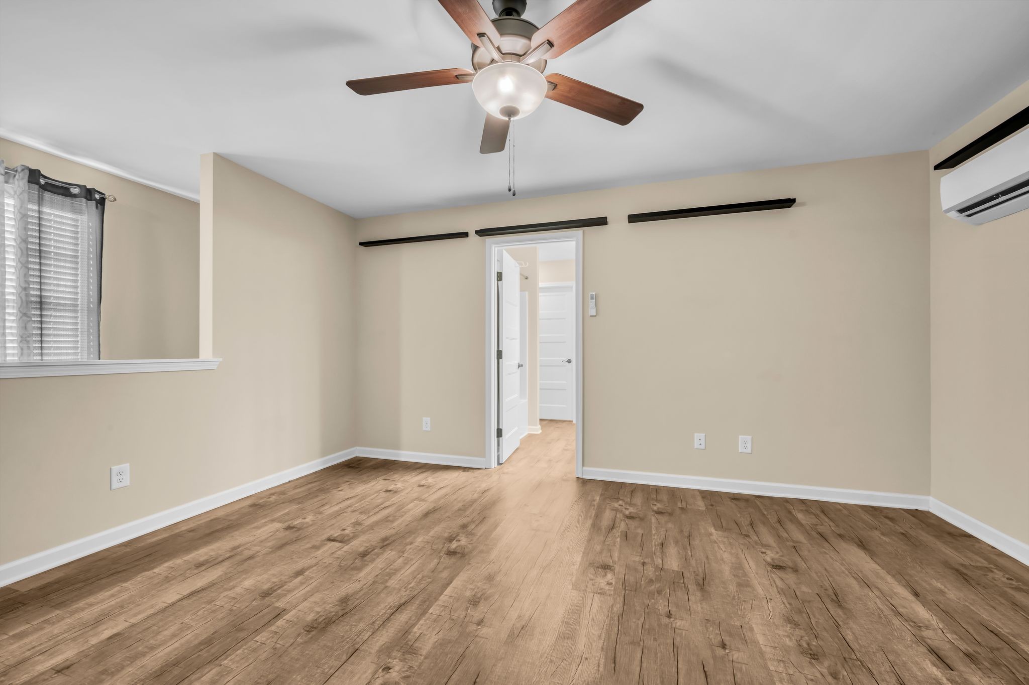 116 Eno Road Dickson, TN 37055 - Photo 19 of 28 a view of an empty room with wooden floor and a ceiling fan