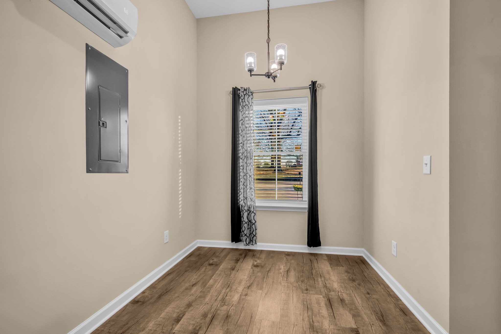 116 Eno Road Dickson, TN 37055 - Photo 6 of 28 an empty room with wooden floor chandelier and windows