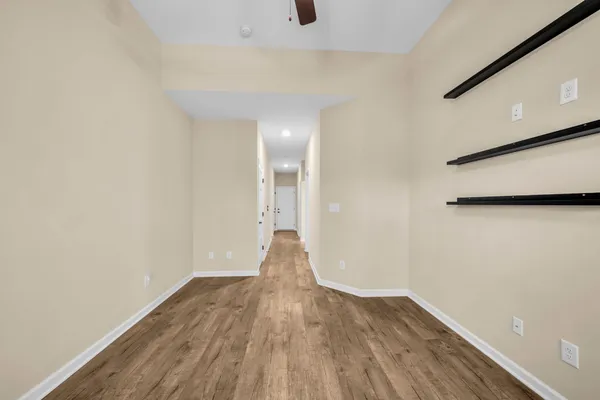 a view of a room with wooden floor