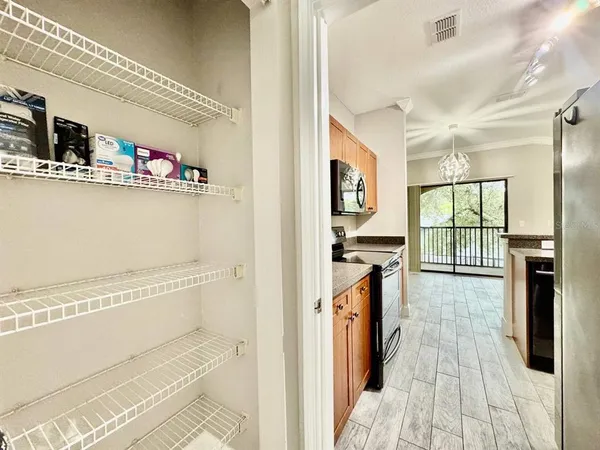 a view of a kitchen with fridge and wooden floor