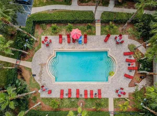 a view of a house with swimming pool and sitting area