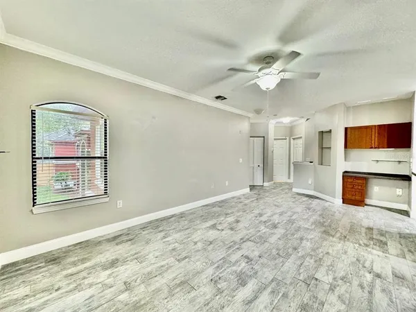 a view of an empty room with a fireplace and a window