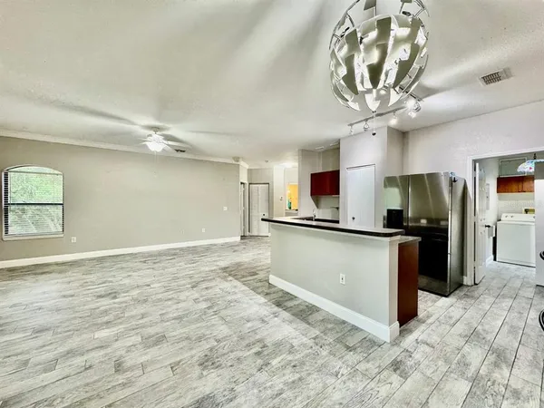 a view of a kitchen with a sink stainless steel appliances and cabinets