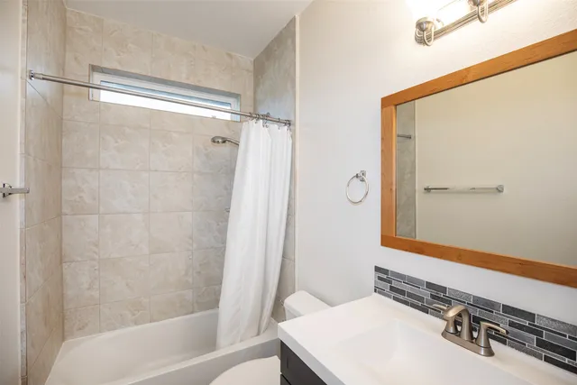 a bathroom with a bathtub and a shower